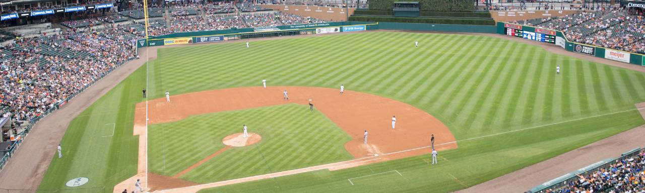 Photo of Comerica Park with players on the field and fans in the stands.
